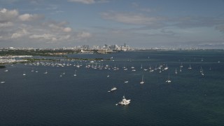 5K aerial stock footage fly over bay and tilt to reveal sailboats and Downtown Miami skyline, Florida Aerial Stock Footage | AX0020_001