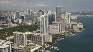 5K aerial stock footage flyby bayfront condominium complexes to approach Downtown Miami hotel and skyscrapers, Florida Aerial Stock Footage | AX0020_019E