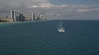 5K aerial stock footage approach a yacht racing across calm ocean near Sunny Isles Beach, Florida Aerial Stock Footage | AX0020_072