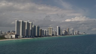 5K aerial stock footage of oceanfront skyscrapers along the coast in Sunny Isles Beach, Florida Aerial Stock Footage | AX0020_073