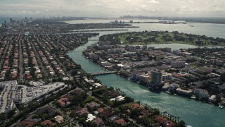 AX0020_093 - 5K aerial stock footage pan across waterfront homes in coastal island neighborhoods in Bal Harbour and Surfside, Florida