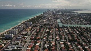 5K aerial stock footage tilt up and fly over coastal residential neighborhoods in Surfside, Florida Aerial Stock Footage | AX0020_095