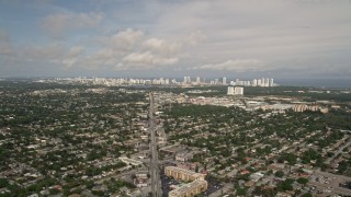 5K aerial stock footage of suburban area with distant coastal skyscrapers in Sunny Isles Beach, Florida Aerial Stock Footage | AX0021_002