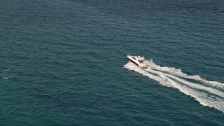 5K aerial stock footage approach fishing boats racing across the blue water of the ocean near South Beach, Florida Aerial Stock Footage | AX0021_043E