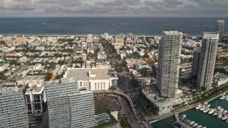 5K aerial stock footage of slow traffic on the MacArthur Causeway, tilt to condos and marina, South Beach, Florida Aerial Stock Footage | AX0021_063E