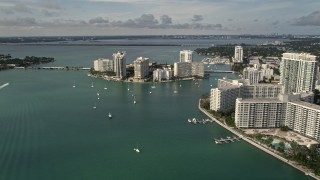 5K aerial stock footage flyby waterfront South Beach condos and hotels to approach Belle Island, Florida Aerial Stock Footage | AX0021_065E