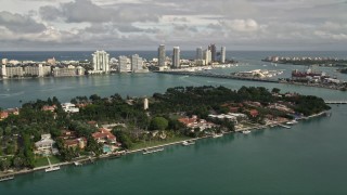 AX0021_068 - 5K aerial stock footage of spacious bayfront mansions on the shore of Star Island, Florida