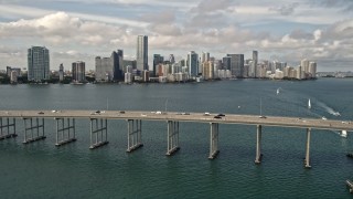 5K aerial stock footage tilt to reveal and approach Rickenbacker Causeway and Downtown Miami skyline, Florida Aerial Stock Footage | AX0021_115E