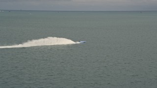 AX0021_153E - 5K aerial stock footage track a sport boat racing across Biscayne Bay, Florida