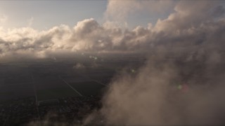 AX0022_001 - 5K aerial stock footage flyby break in the clouds at sunset over Kendall, Florida