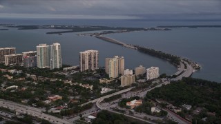 5K aerial stock footage of waterfront condo complexes and the Rickenbacker Causeway in Downtown Miami at sunset, Florida Aerial Stock Footage | AX0022_025