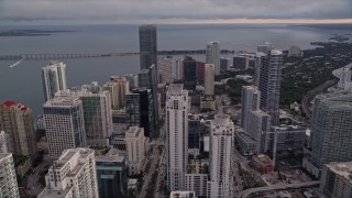 5K aerial stock footage fly over Downtown Miami skyscrapers toward the Rickenbacker Causeway at sunset, Florida Aerial Stock Footage | AX0022_039E