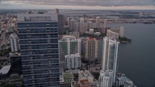 5K aerial stock footage orbit top of Four Seasons Hotel to reveal waterfront skyscrapers in Downtown Miami at sunset, Florida Aerial Stock Footage | AX0022_043