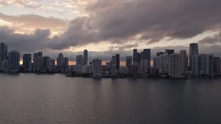 5K aerial stock footage of Downtown Miami skyline at sunset seen from Biscayne Bay, Florida Aerial Stock Footage | AX0022_054E