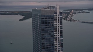 5K aerial stock footage flyby the top of the Four Seasons Hotel tower at sunset in Downtown Miami, Florida Aerial Stock Footage | AX0022_069E