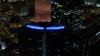 5K aerial stock footage orbit colorful lights on the roof of Epic Hotel at night in Downtown Miami, Florida Aerial Stock Footage | AX0023_012E