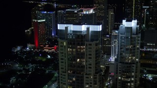 5K aerial stock footage of illuminated rooftops of Vizcayne towers at Night in Downtown Miami, Florida Aerial Stock Footage | AX0023_025E