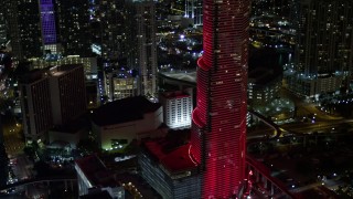 5K aerial stock footage of Miami Tower changing colors at night in Downtown Miami, Florida Aerial Stock Footage | AX0023_027