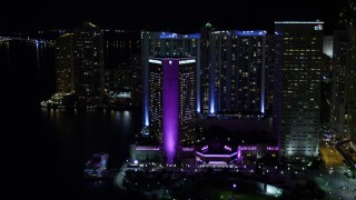 5K aerial stock footage tilt from Bayside Marketplace to reveal InterContinental in Downtown Miami at night, Florida Aerial Stock Footage | AX0023_045E