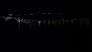 AX0023_052 - 5K aerial stock footage of tracking an emergency helicopter flying over Biscayne Bay at night, Florida