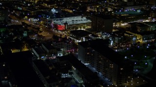 5K aerial stock footage of cafes and shops on an intersection at night in South Beach, Florida Aerial Stock Footage | AX0023_070