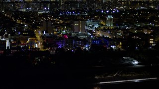 5K aerial stock footage of Ocean Drive hotels with bright lights at night in South Beach, Florida Aerial Stock Footage | AX0023_073