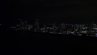 AX0023_074 - 5K aerial stock footage of South Beach seen from the ocean at night in Florida