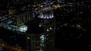 5K aerial stock footage tilt to the Fontainebleau Miami Beach Resort rooftop at night, Florida Aerial Stock Footage | AX0023_093E