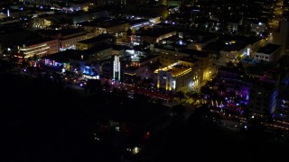 AX0023_110E - 5K aerial stock footage of row of hotels on Ocean Drive at night in South Beach, Florida