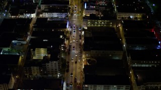 AX0023_114E - 5K aerial stock footage fly over cars on Collins Avenue at night through South Beach, Florida