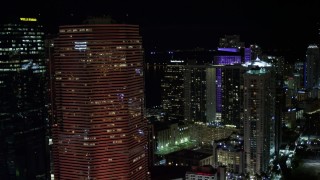 5K aerial stock footage of passing Miami Tower with orange lighting at night in Downtown Miami, Florida Aerial Stock Footage | AX0023_145E