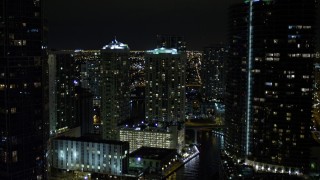 5K aerial stock footage fly over Miami River past skyscrapers at night in Downtown Miami, Florida Aerial Stock Footage | AX0023_155E