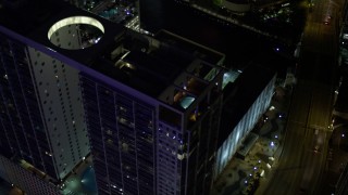 5K aerial stock footage approach 500 Brickell and tilt to rooftop pool at night in Downtown Miami, Florida Aerial Stock Footage | AX0023_168