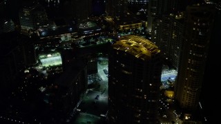 5K aerial stock footage orbit skyscraper's rooftop on Brickell Key at night in Downtown Miami, Florida Aerial Stock Footage | AX0023_176E