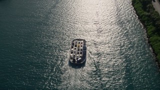 AX0024_072 - 5K aerial stock footage of approaching ferry sailing on Government Cut, tilt down, Miami Beach, Florida