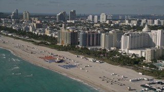 5K aerial stock footage of flying along the shore of South Beach and passing hotels, Miami Beach, Florida Aerial Stock Footage | AX0024_093