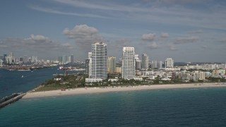 AX0024_112 - 5K aerial stock footage of flying over Atlantic Ocean, reveal South Beach skyscrapers, Miami Beach, Florida