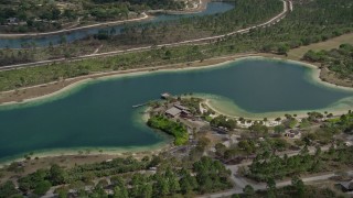 AX0025_005 - 5K aerial stock footage of flying by a lake, Zoo Miami, Miami, Florida