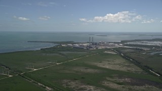 5K aerial stock footage of flying by power lines, revealing Turkey Point Power Plant, Homestead, Florida Aerial Stock Footage | AX0025_020