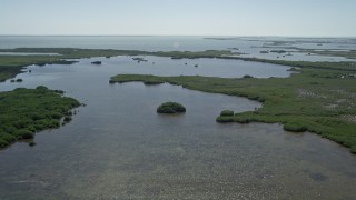 AX0025_031 - 5K aerial stock footage of flying over coastal lagoon, Homestead, Florida