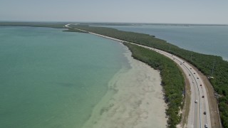 AX0025_049 - 5K aerial stock footage of following light traffic on Overseas Highway, Key Largo, Florida