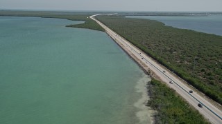 AX0025_050 - 5K aerial stock footage of light traffic on Overseas Highway, Key Largo, Florida