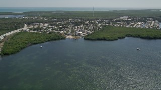 5K aerial stock footage of flying over Lake Surprise toward neighborhood, Key Largo, Florida Aerial Stock Footage | AX0025_055