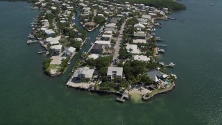 AX0025_058 - 5K aerial stock footage of approaching homes on shore of Sexton Cove, Key Largo, Florida