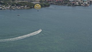 5K aerial stock footage of speedboat pulling parasailers on Blackwater Sound, Key Largo, Florida Aerial Stock Footage | AX0025_061