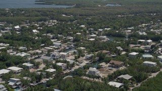 5K aerial stock footage of flying by homes on canals, Key Largo, Florida Aerial Stock Footage | AX0025_062