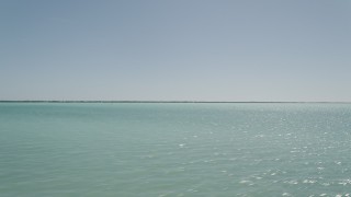 5K aerial stock footage of flying low over water past the coast, Tavernier, Florida Aerial Stock Footage | AX0025_078