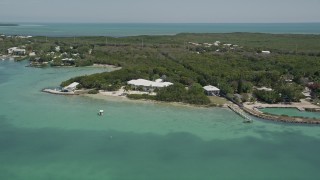 5K aerial stock footage of flying by a home on the shore, Tavernier, Florida Aerial Stock Footage | AX0025_085