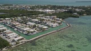 5K aerial stock footage of flying by waterfront homes on the shore, Tavernier, Florida Aerial Stock Footage | AX0025_087