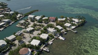 5K aerial stock footage of panning across homes along the shore, tilt down, Tavernier, Florida Aerial Stock Footage | AX0025_092